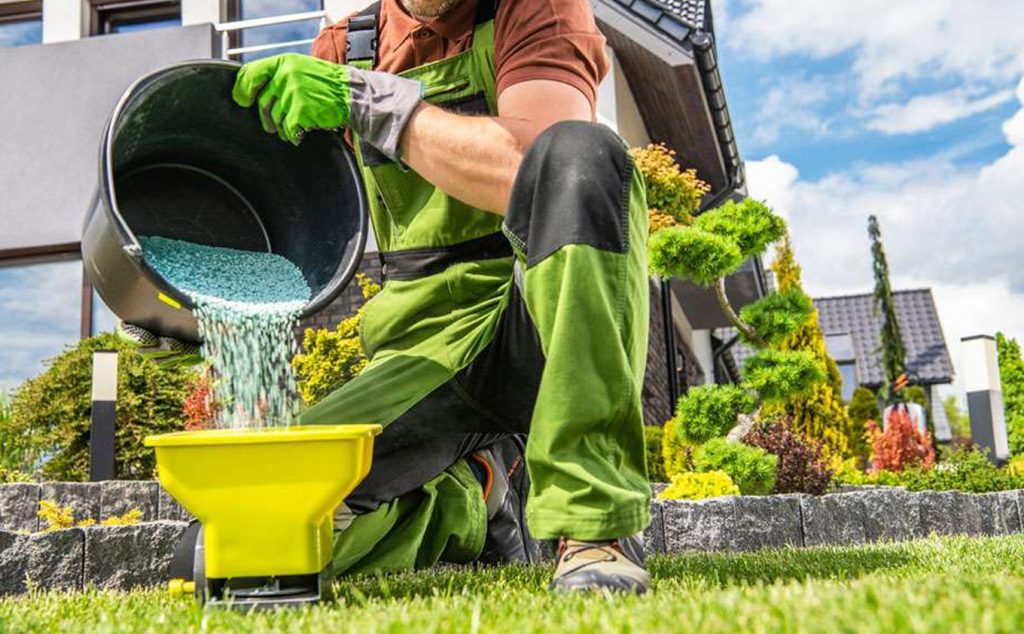 garden worker preparing grass fertilizer 1